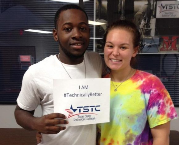 black male student holding #technicallybetter sign